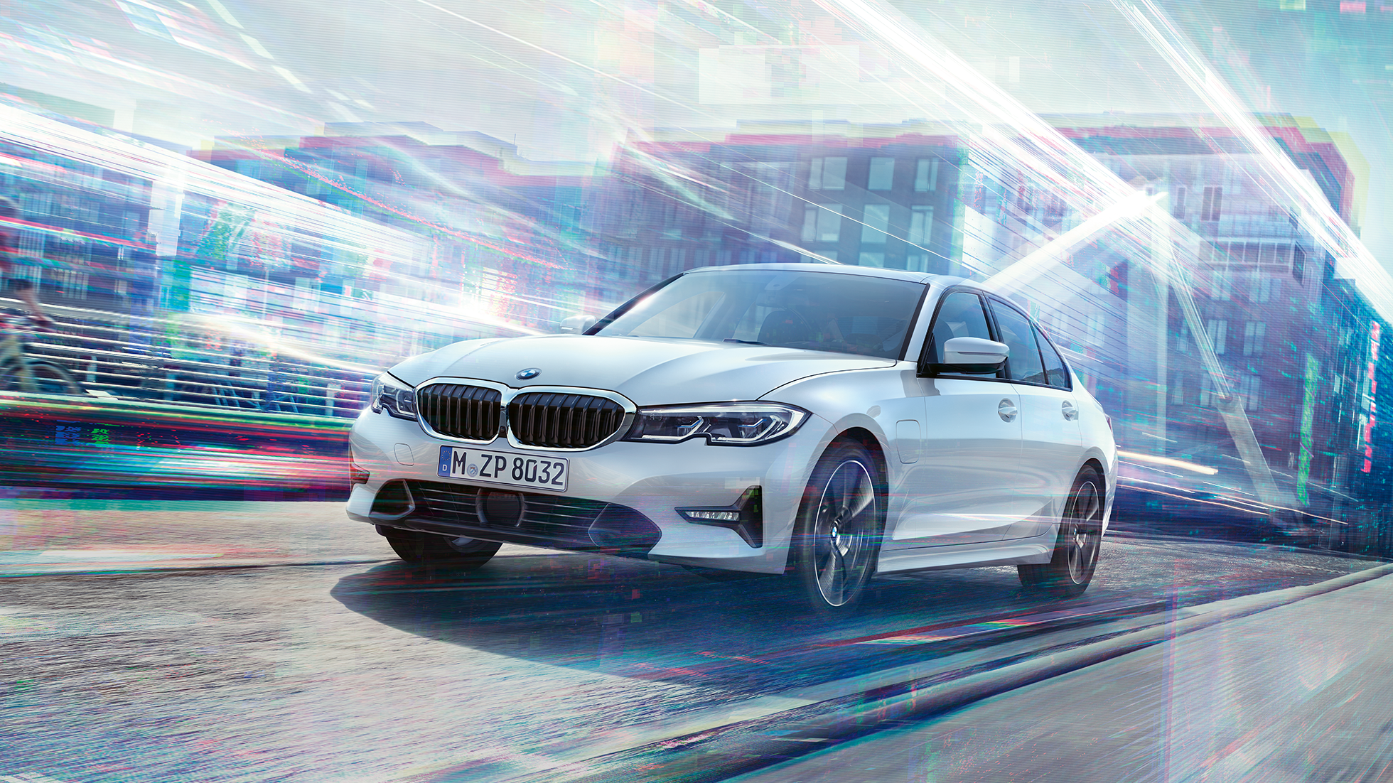 BMW 3 Series Sedan 330e driving against an urban backround.