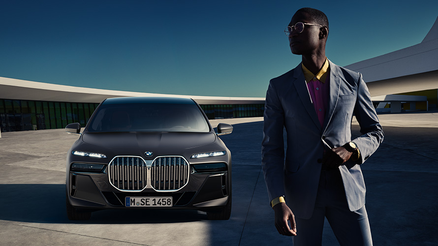BMW Diplomatic Sales benefits for diplomats Presale Service man in front of BMW diplomatic vehicle